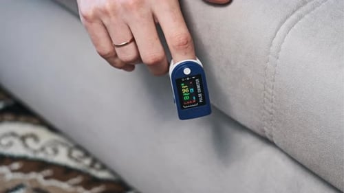 Pulse Oximeter Used on Finger Inside Home