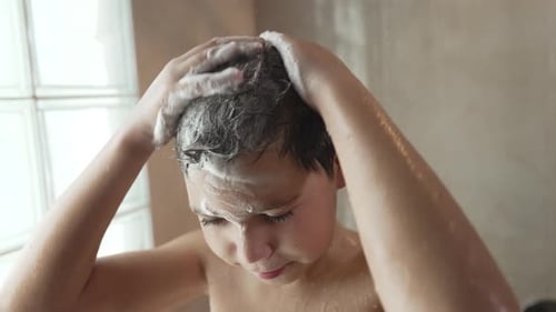 Boy Washing Hair with Shampoo in Shower