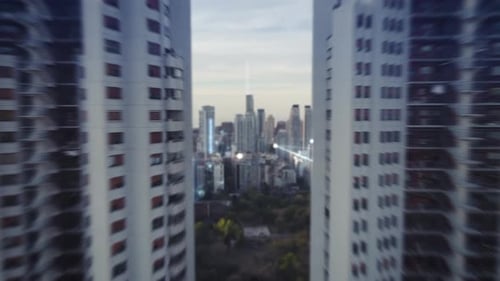 Future concept with glowing digital lines connecting city - Cinematic drone flight between twin skys