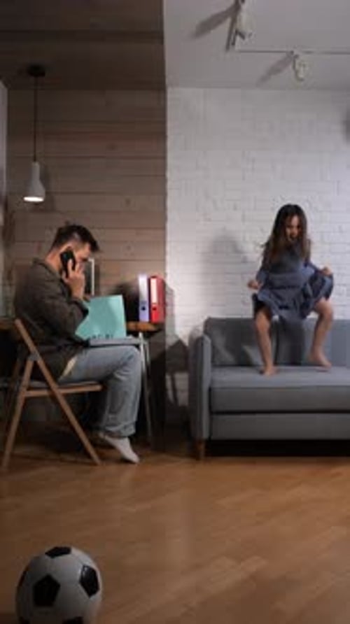 Vertical Video Father Working From His Home Office on Smartphone and Laptop Struggling to