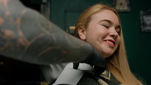 Piercing studio interior - piercing master makes a piercing to a girl, ear piercing