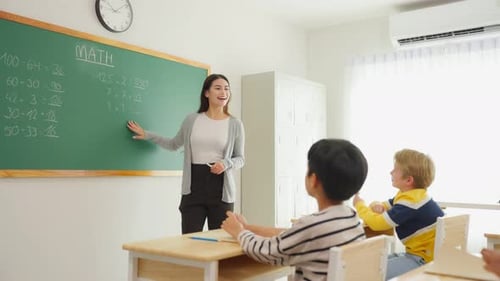 Group of student learn with teacher in classroom at elementary school.