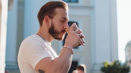 Young Man Guy Enjoying Drinking Morning Coffee Hot Drink Relaxing Taking a Break in City Street