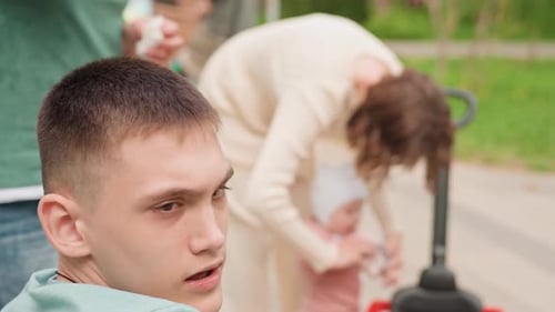 Man Observing Child And Caregiver Young Man Seated On Park Bench Observing Child Care Interaction
