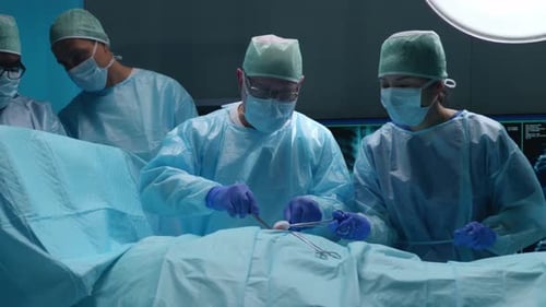 Team of Professional Medical Surgeons Performs the Surgical Operation in a Modern Hospital Doctors