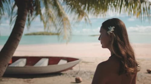 Tourist Relaxing Under Palm Tree on Tropical Island Beach