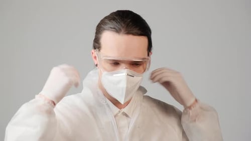 Man Wearing Protective Suit, Mask, and Goggles