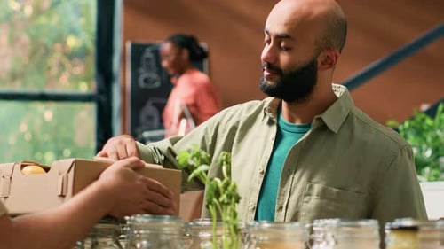 Man Purchases Apple at Local Food Business