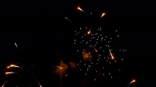 Amazing pyrotechnic display lights up the sky to mark a celebration. Golden sparkles and flashes bur