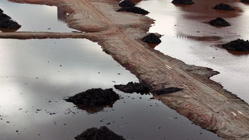 A muddy area with a dirt road