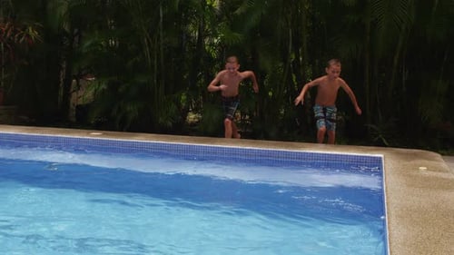 Two Boys Jump Into Swimming Pool, Slow Moiton America