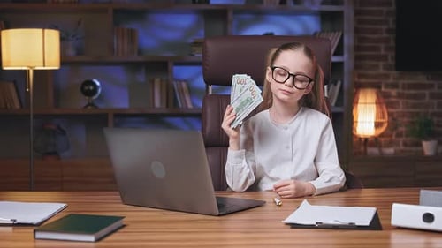 Schoolgirl Waving Dollar Bills with Closed Eyes in Office