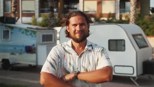 Young Adult Smiling near Recreational Vehicles