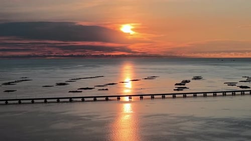 The sun is setting over the ocean. Aerial view Penang Second Bridge
