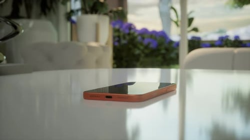 White Paper Airplane Icon Flying Above a Smartphone on a White Table
