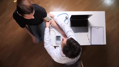 Doctor Takes Blood Pressure of Female Patient