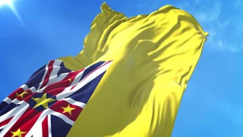 Niue National Flag Waving in Realistic 3D Animation Against Blue Sky