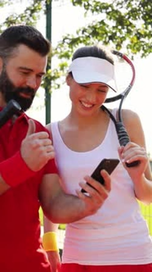 Tennis Players Collaborating and Sharing Valuable Insights While Enjoying Their Time on the Court