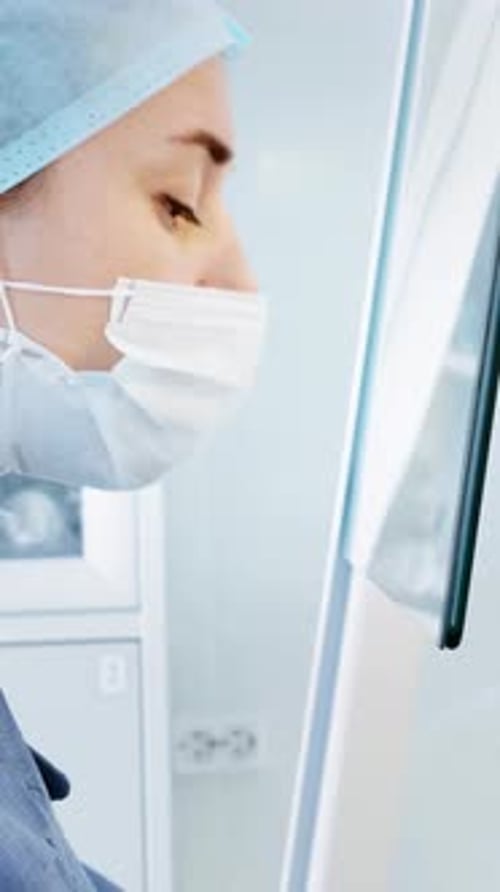 Focused Woman Doctor in Face Mask at Hospital