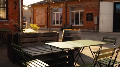Real Estate Property Featuring Brick Building with Tables and Chairs Outside
