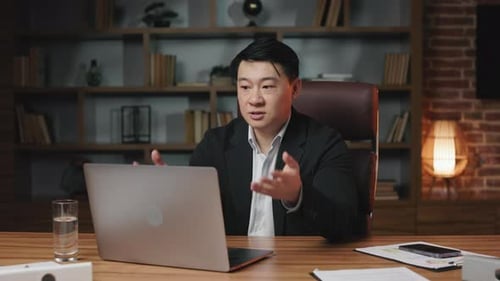 Manager Discussing Startup During Video Call in Office