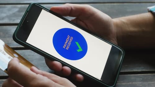 Woman Paying Online Using Smartphone and Bank Credit Card