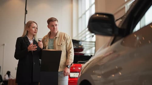 Successful Woman Seller Consulting in Auto Showroom Help Male Customer Choosing New Modern Electric