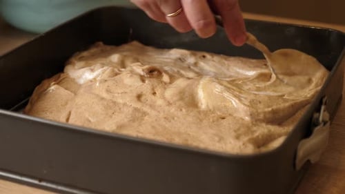 Cake Batter Being Spread into Baking Pan