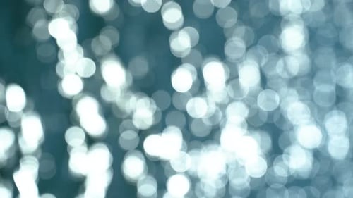 Shimmering Bokeh Highlights on Blue Sea Background