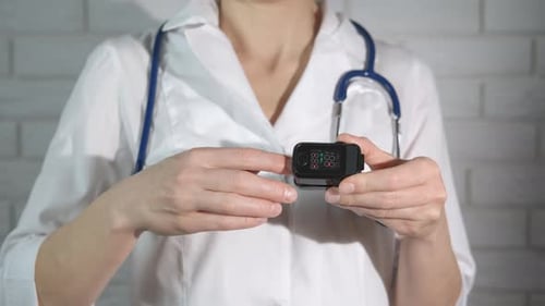 Medical Professional Demonstrates Pulse Oximeter Use