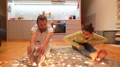 Man and Woman Stretching in Yoga Pose