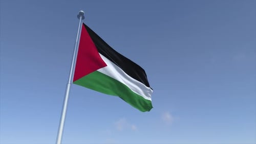 Palestinian Flag Waving Proudly Against Blue Sky