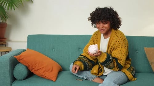 Saving Money Investment for Future African American Girl Holding Pink Piggy Bank and Putting Money