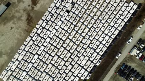 High Angle Aerial View of Massive White Truck Trailer Fleet