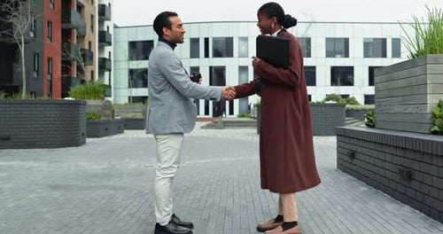 Professional, people and smile with handshake in city for introduction, greeting or welcome