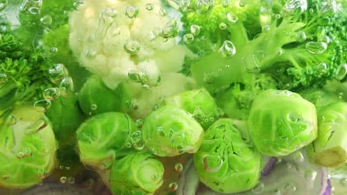 Vegetable mix for making soup in boiling water with air bubbles.