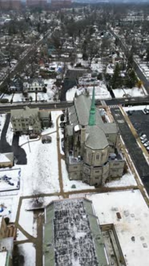 Aerial drone footage of South Jersey in winter, featuring snow-covered rooftops, streets, and urban