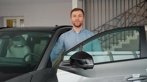 Male Buyer Client Chooses Auto Wants to Buy New Automobile Touch Check Car in Showroom