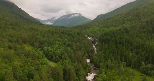 Freshwater Stream Flowing Forested Rocky Mountains On The West Coast, Norway. Aerial Drone Shot
