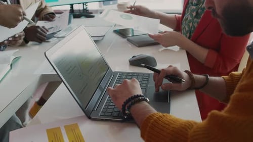 Diverse Team Collaborating on Project in Modern Office