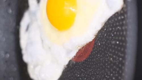 Egg frying in a pan close up