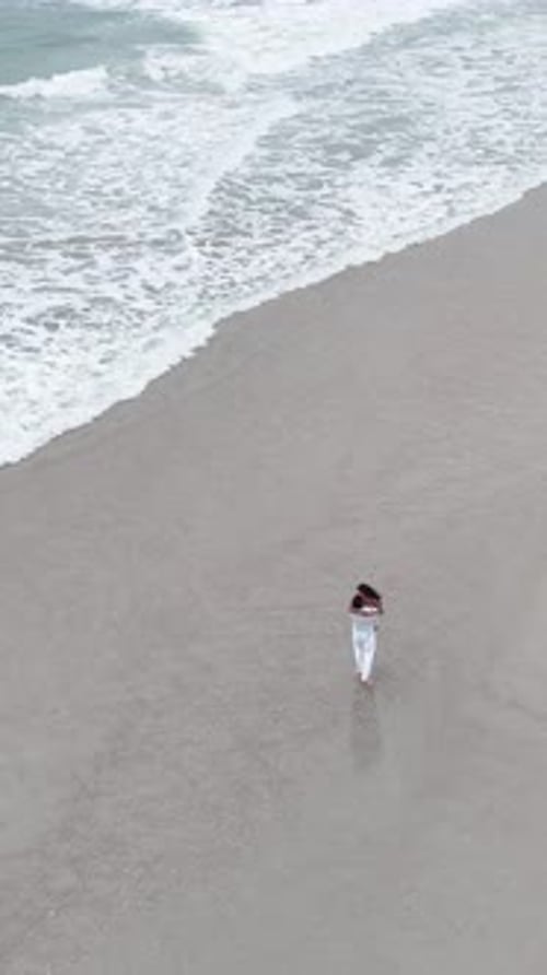 Romantic Couple Embracing and Dancing on a Sandy Beach
