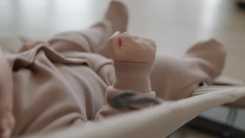 Sweet Baby Relaxing in Bouncer at Home
