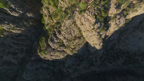 Aerial View Two Friends Posing on a Cliff With a Breathtaking Canyon View in Turkey