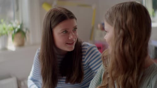 Two Friends Writing Together at Home