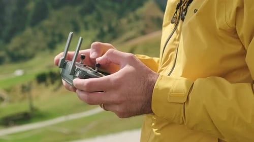 Drone Pilot Rotates Joystick of Controller Giving Commands
