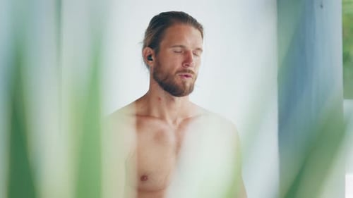 Young Fit Man Does Yoga Meditating Exercises Caucasian Man Meditates in the Room