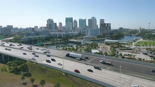 Aerial drone shot of Downtown Tampa skyline with busy morning vehicle traffic on I-275