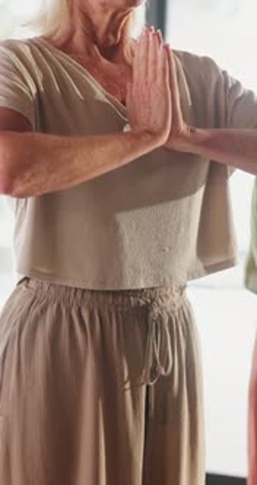Senior Woman Meditating in Home Studio with Hands
