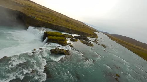 Aerial View of Powerful Waterfall and Rugged Landscape